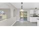 Bright dining area features tile floors, decorative lighting and sliding glass doors at 2120 Marisol Loop, Kissimmee, FL 34743