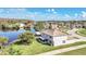 A picturesque view of the two-story home with a screened in porch, backing onto a tranquil lake setting at 2120 Marisol Loop, Kissimmee, FL 34743