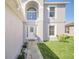 Inviting front entrance showcasing a decorative glass door and well-kept landscaping at 2120 Marisol Loop, Kissimmee, FL 34743