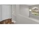 Bright hallway features wood floors, neutral walls, large window, and access to upstairs bedrooms and bathrooms at 2120 Marisol Loop, Kissimmee, FL 34743