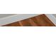 Close-up of hardwood flooring, emphasizing its warm tones and texture at 2120 Marisol Loop, Kissimmee, FL 34743