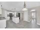 Spacious kitchen with an island, stainless steel appliances, and modern lighting at 2120 Marisol Loop, Kissimmee, FL 34743
