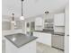 Kitchen with an island, stainless steel appliances, white cabinets, and view of the backyard at 2120 Marisol Loop, Kissimmee, FL 34743
