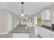 Bright kitchen with an island, modern lighting, and easy access to the living area and patio at 2120 Marisol Loop, Kissimmee, FL 34743