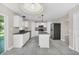Bright kitchen featuring an island, stainless steel appliances, and modern lighting at 2120 Marisol Loop, Kissimmee, FL 34743