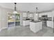 Kitchen with an island, stainless steel appliances, white cabinets, and sliding door to patio at 2120 Marisol Loop, Kissimmee, FL 34743