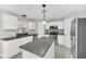 Kitchen featuring an island, stainless steel appliances, and modern backsplash at 2120 Marisol Loop, Kissimmee, FL 34743