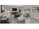 Cozy living room with tile floors, stylish furnishings, and a large window at 2120 Marisol Loop, Kissimmee, FL 34743