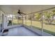 Spacious screened patio features a ceiling fan and views of the landscaped backyard at 2120 Marisol Loop, Kissimmee, FL 34743