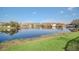 Scenic view of the tranquil pond surrounded by lush greenery at 2120 Marisol Loop, Kissimmee, FL 34743