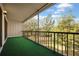 A covered balcony with artifical turf offers serene views of the surroundings at 230 Moree Loop # 4, Winter Springs, FL 32708
