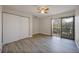 Bright bedroom with a ceiling fan, wood-look floors, and a sliding door to a balcony at 230 Moree Loop # 4, Winter Springs, FL 32708