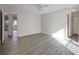 Bright Primary bedroom featuring white walls, laminated floors, ceiling fan, and an ensuite bathroom at 230 Moree Loop # 4, Winter Springs, FL 32708