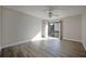 Bedroom with laminated floor, ceiling fan, white trim, and a sliding glass door to the balcony at 230 Moree Loop # 4, Winter Springs, FL 32708