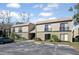 Exterior view of a two-story apartment building with car park, dark trim, and neutral beige siding at 230 Moree Loop # 4, Winter Springs, FL 32708