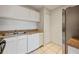Well-maintained kitchen with white appliances, white cabinets, and laminate countertop at 230 Moree Loop # 4, Winter Springs, FL 32708