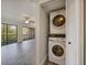 Cozy living room with balcony access and stacked washer and dryer in the closet at 230 Moree Loop # 4, Winter Springs, FL 32708