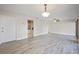 Open-concept living room and kitchen with new gray laminate flooring, ceiling fan, and bright lighting at 230 Moree Loop # 4, Winter Springs, FL 32708