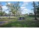 A well-kept park has picnic tables and a fenced playground with multiple play structures for lots of active fun at 230 Moree Loop # 4, Winter Springs, FL 32708