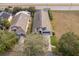 Aerial shot of the home's roof, driveway, and landscaping, showing its location near the highway at 2551 Bear Creek Ct, Kissimmee, FL 34747