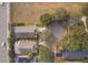 Overhead view of the property's setting and proximity to road, trees, and neighboring homes at 2551 Bear Creek Ct, Kissimmee, FL 34747