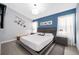 Cozy bedroom with a modern bed frame, soft lighting, and calming blue accent wall, creating a peaceful retreat at 2551 Bear Creek Ct, Kissimmee, FL 34747