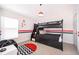' room featuring a bunk bed with red and black accents and matching decor at 2551 Bear Creek Ct, Kissimmee, FL 34747