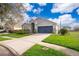 Single-story home showcasing a blue garage door and well-maintained lawn on a corner lot at 2551 Bear Creek Ct, Kissimmee, FL 34747