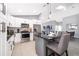 Modern kitchen with white cabinets, stainless steel appliances and a center island with seating at 2551 Bear Creek Ct, Kissimmee, FL 34747