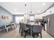 Contemporary kitchen boasts white cabinets, stainless steel appliances, island seating, and breakfast nook at 2551 Bear Creek Ct, Kissimmee, FL 34747