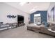 Inviting living room with ample seating, a large TV, bright skylights and smooth flooring throughout at 2551 Bear Creek Ct, Kissimmee, FL 34747