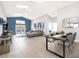 Bright, open-concept living space featuring vaulted ceilings, modern decor, and seamless access to the outdoor patio at 2551 Bear Creek Ct, Kissimmee, FL 34747