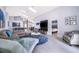 The spacious living area features an open floor plan, modern furnishings, and seamless access to the dining area at 2551 Bear Creek Ct, Kissimmee, FL 34747