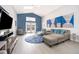 Open-concept living room featuring modern furnishings, a large sofa, stylish art, and a bright, airy atmosphere at 2551 Bear Creek Ct, Kissimmee, FL 34747