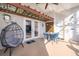 Covered patio with a unique egg chair, dining set, and decorative accents at 2551 Bear Creek Ct, Kissimmee, FL 34747