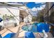 Screened in pool area with lounge chairs and a beautiful blue sky at 2551 Bear Creek Ct, Kissimmee, FL 34747