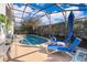 Screened-in pool area with lounge chairs and a clear blue sky at 2551 Bear Creek Ct, Kissimmee, FL 34747