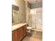 Bathroom with double vanity, wood cabinets, and a large glass shower at 2586 Grand Central Pkwy # 1, Orlando, FL 32839