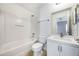 Bright bathroom with white vanity, integrated sink, shower-tub combo, and neutral decor for a clean and functional space at 2605 Andros Ln, Kissimmee, FL 34747