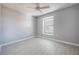 Cozy bedroom featuring neutral walls, vinyl floors, and a ceiling fan at 2605 Andros Ln, Kissimmee, FL 34747
