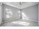 Light-filled bedroom with modern wood-look flooring, ample sunlight, and a contemporary ceiling fan creating a comfortable atmosphere at 2605 Andros Ln, Kissimmee, FL 34747