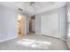 Spacious bedroom with wood-look floors, a ceiling fan, ample storage, and convenient access to an en-suite bathroom at 2605 Andros Ln, Kissimmee, FL 34747