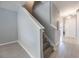 Inviting home hallway with stairs, fresh gray walls, and durable wood-look floors, enhancing a modern and clean feel at 2605 Andros Ln, Kissimmee, FL 34747