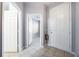 Hallway view through doorway to a spacious room with neutral colors, wood-look floors, and ample natural light at 2605 Andros Ln, Kissimmee, FL 34747