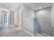 Hallway featuring new gray floors with doors leading to other rooms at 2605 Andros Ln, Kissimmee, FL 34747