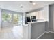 Eat-in kitchen with white cabinets, black appliances, and easy access to an outdoor area at 2605 Andros Ln, Kissimmee, FL 34747