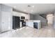 Bright kitchen with white cabinets, black appliances, and tile flooring, offering a modern and functional space at 2605 Andros Ln, Kissimmee, FL 34747