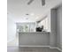 Open-concept living space with modern gray flooring and an adjacent kitchen area at 2605 Andros Ln, Kissimmee, FL 34747