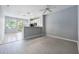 Bright living space with gray flooring, smooth transitions, and lots of natural light at 2605 Andros Ln, Kissimmee, FL 34747