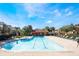 Sparkling community pool surrounded by lush landscaping and lounge chairs at 2605 Andros Ln, Kissimmee, FL 34747